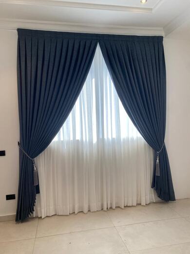 Curtains hung over a voile by KD Dream Space Designs