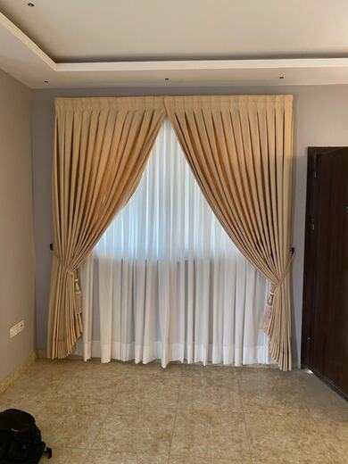 Curtains hung over a voile by KD Dream Space Designs