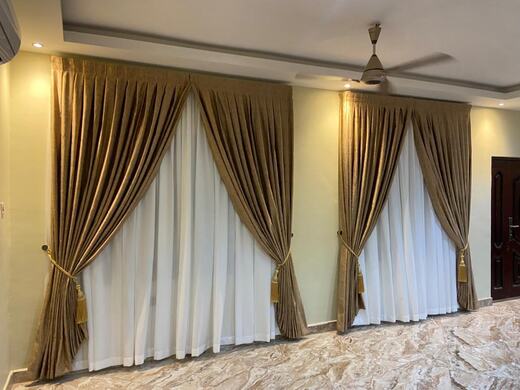 Curtains hung over a voile by KD Dream Space Designs