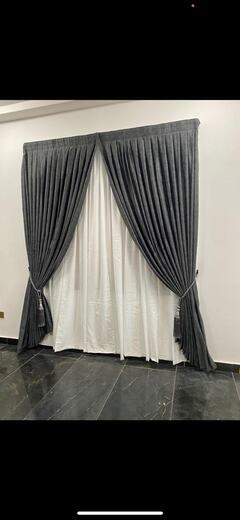 Curtains hung over a voile by KD Dream Space Designs