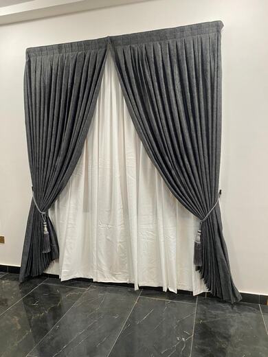 Curtains hung over a voile by KD Dream Space Designs