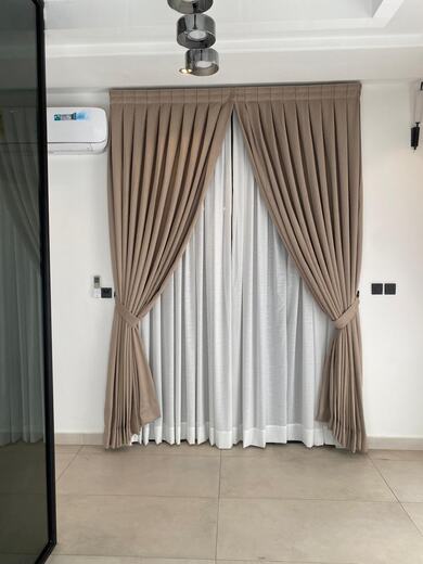 Curtains hung over a voile by KD Dream Space Designs