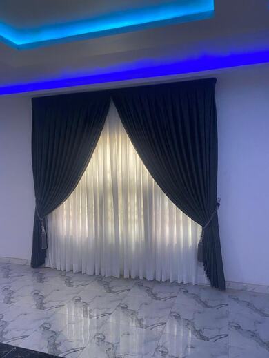 Curtains hung over a voile by KD Dream Space Designs