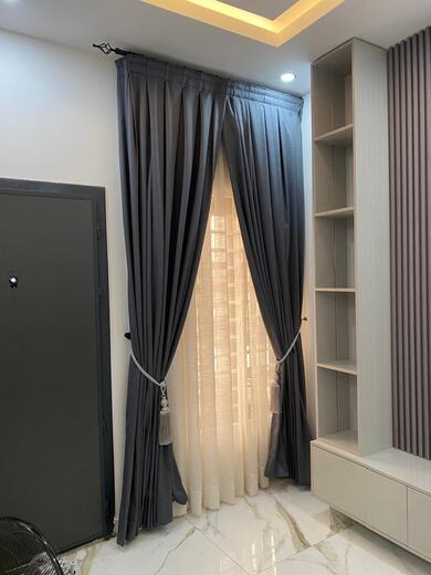 Curtains hung over a voile by KD Dream Space Designs
