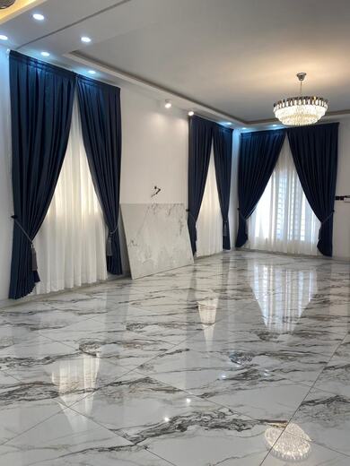 Curtains hung over a voile by KD Dream Space Designs