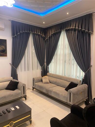 Curtains hung over a voile by KD Dream Space Designs