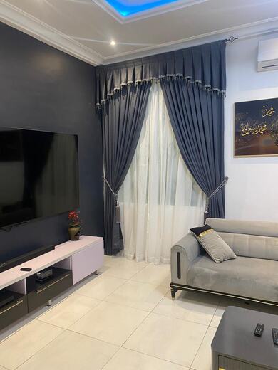 Curtains hung over a voile by KD Dream Space Designs