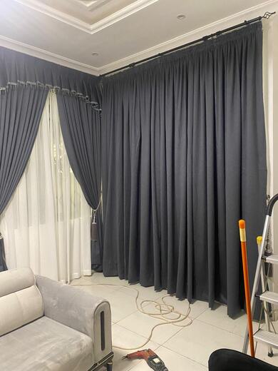 Curtains hung over a voile by KD Dream Space Designs