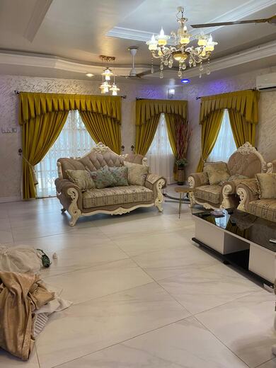 Curtains hung over a voile by KD Dream Space Designs