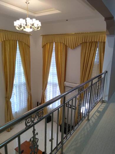 Curtains hung over a voile by KD Dream Space Designs